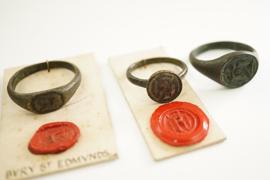 A collection of six bronze signet rings, England, circa 16th century, each engraved with an initial, largest size V, Provenance: formerly in the collection of Dame Joan Evans (1893-1977)
